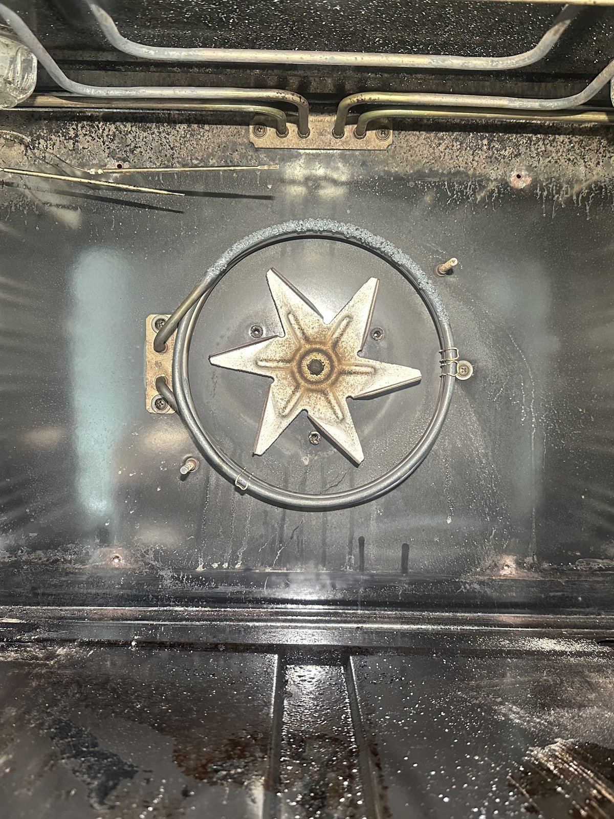 Bertazzoni convection oven interior showing corroded convection heating element around the fan before replacement