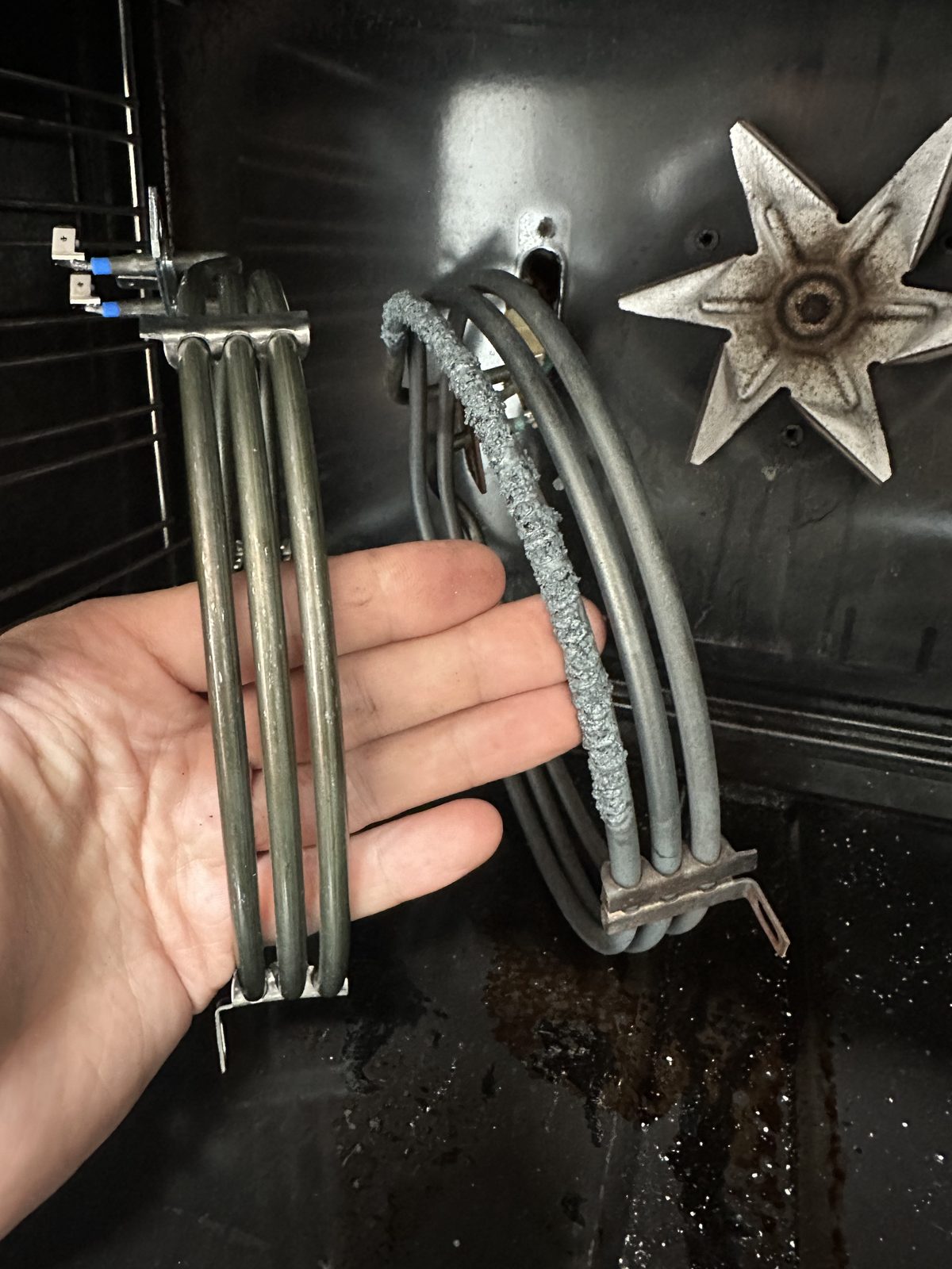 Bertazzoni oven heating element replacement, old corroded element next to new one