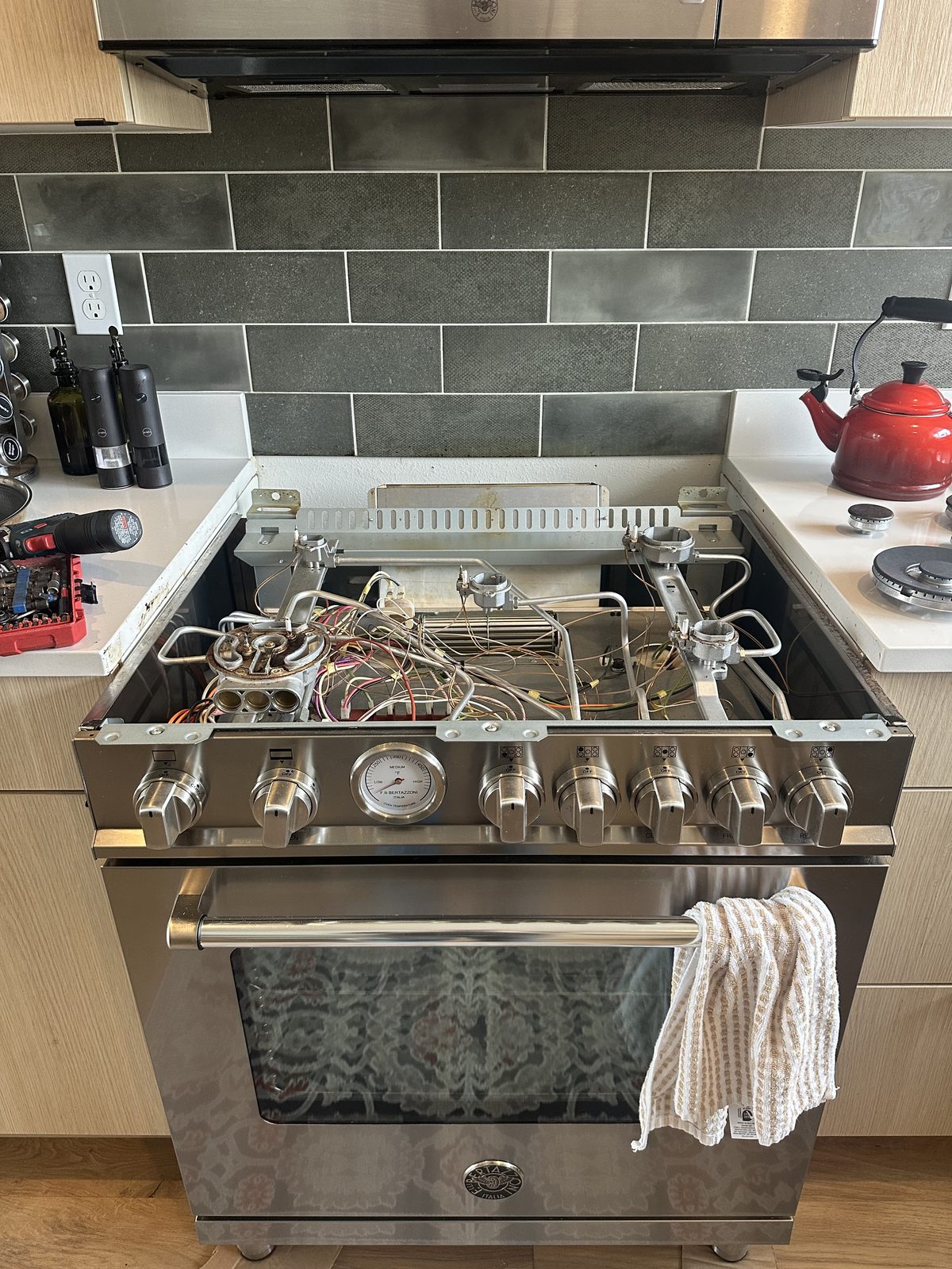 Bertazzoni range control panel and oven thermostat gauge during service