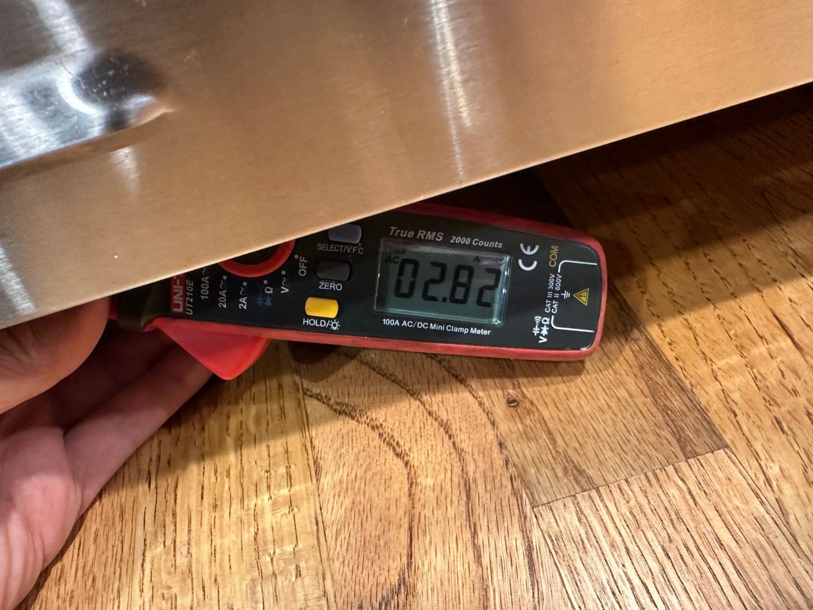 Clamp meter held under the BlueStar range reading 2.82 amps AC on the bake igniter circuit