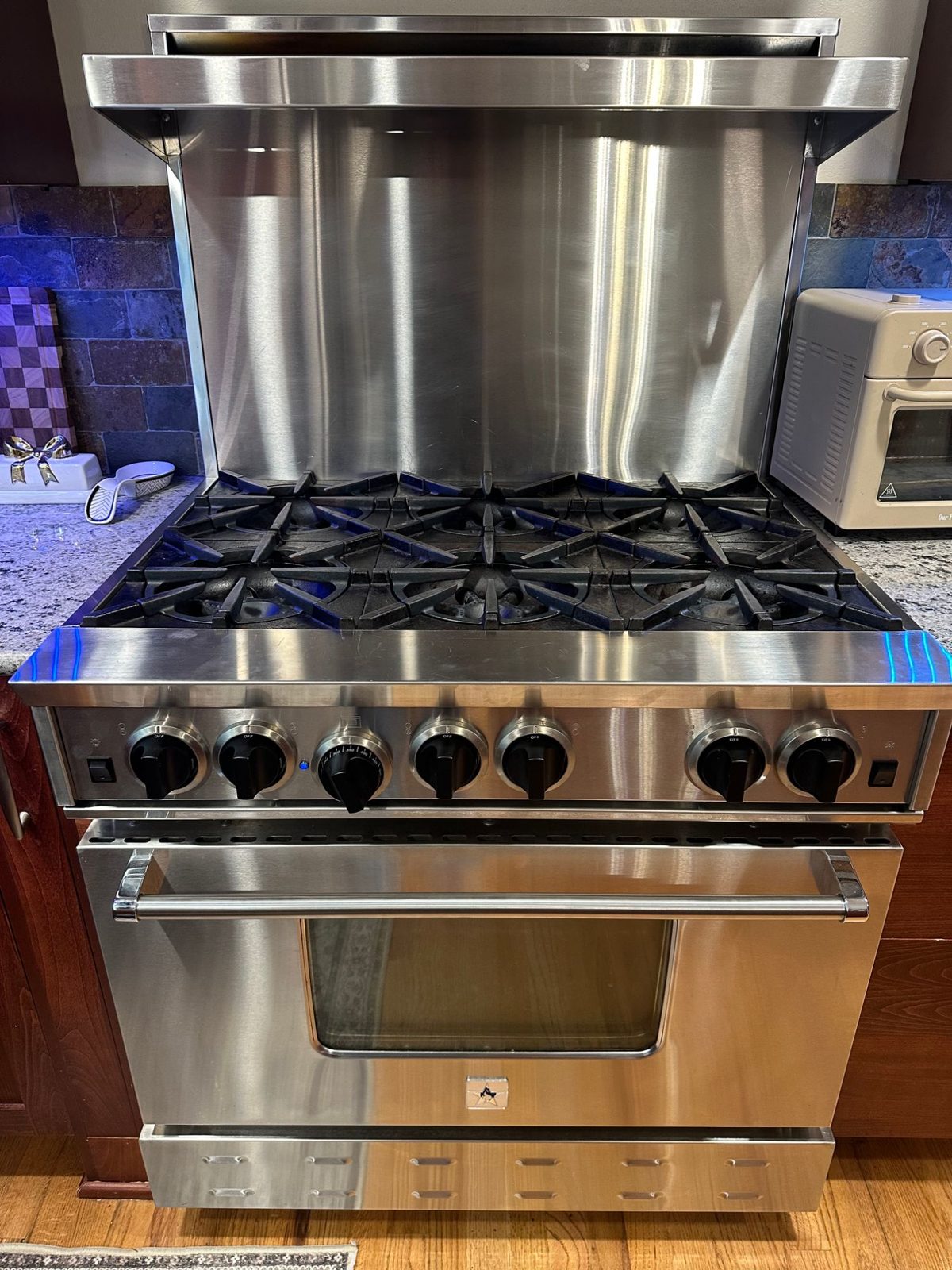 BlueStar 36-inch six-burner range fully reassembled with grates in place and the oven door closed