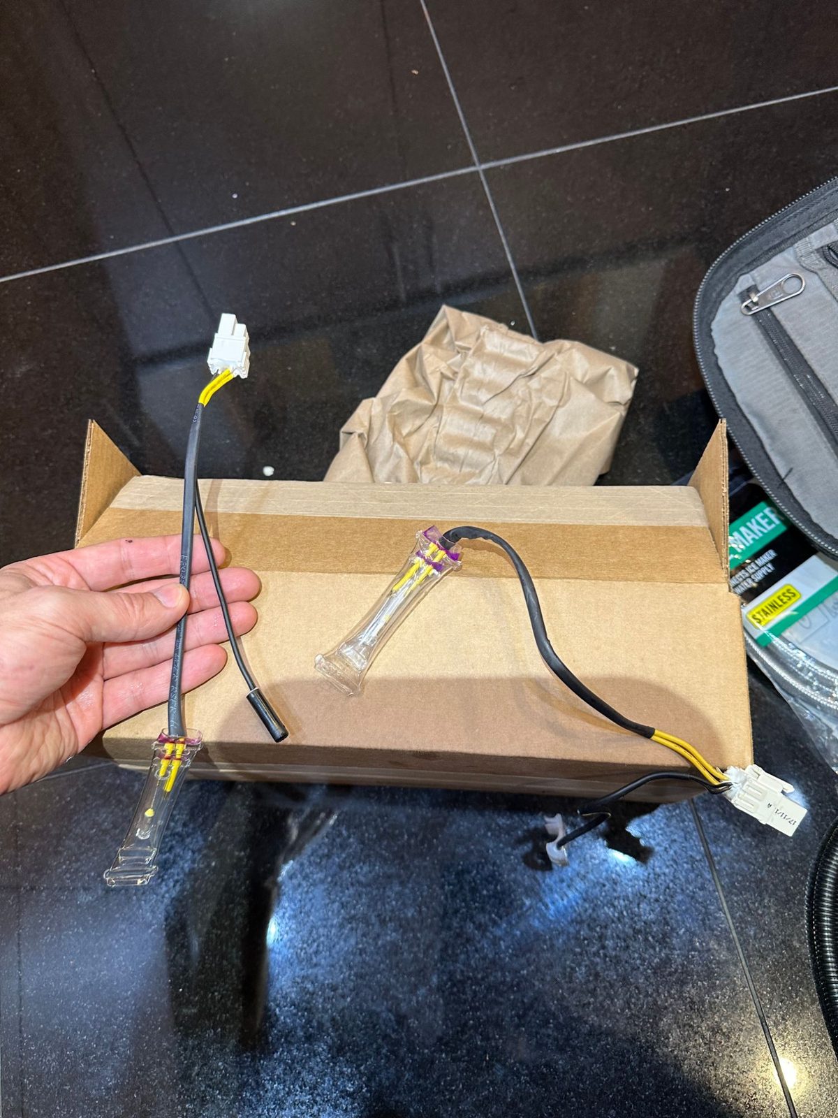 Old and new Bosch defrost sensors side by side, each with its wiring lead and white connector