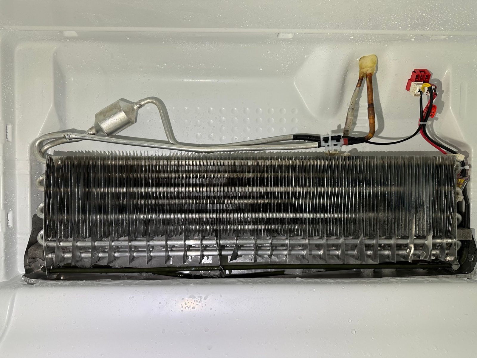 Bosch evaporator coil fully clear of ice after the repair, fins and tubing visible
