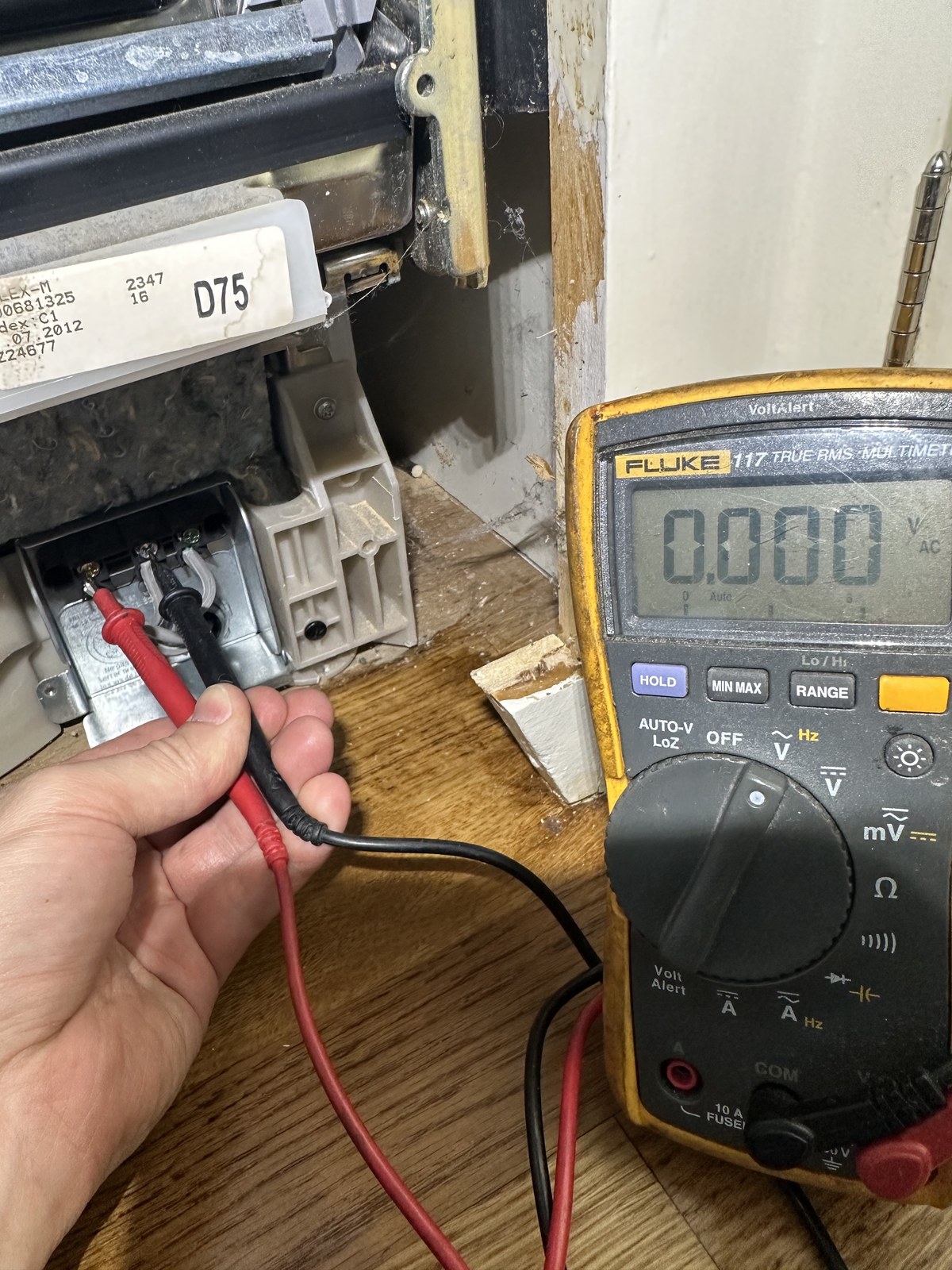 Testing a Bosch dishwasher's power supply wiring with a digital multimeter