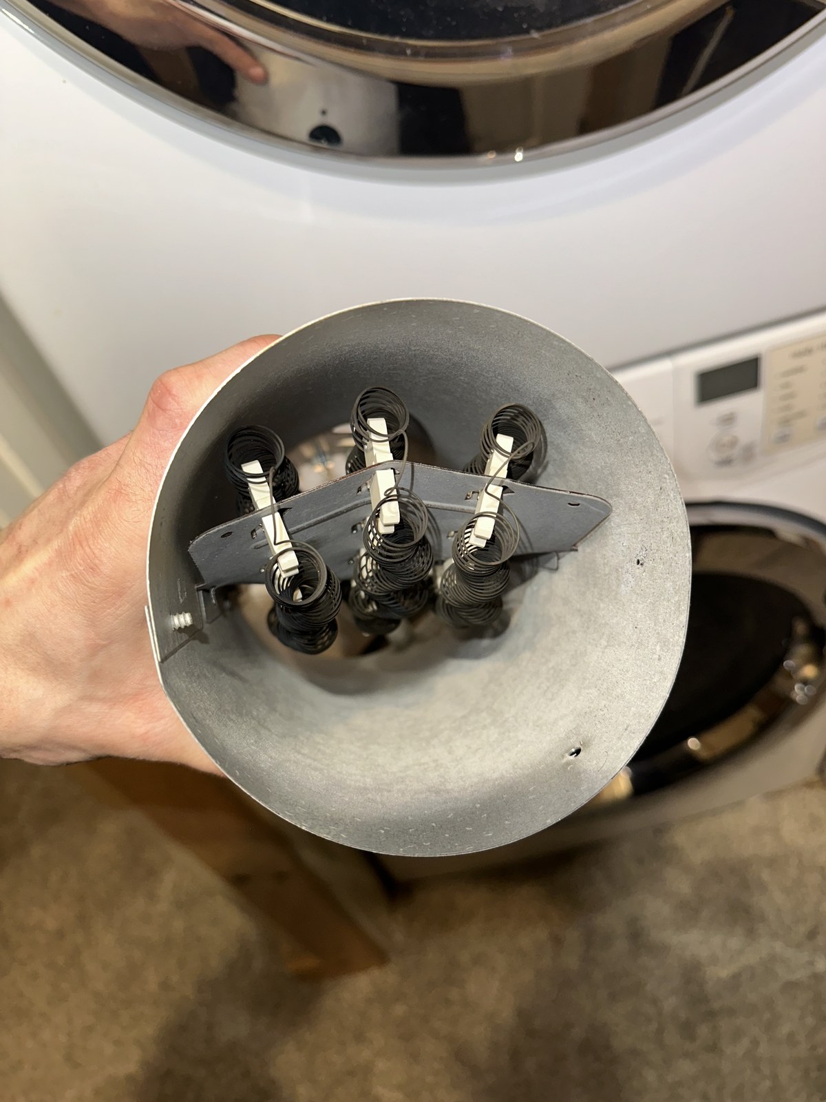 Frigidaire dryer heating element assembly removed from the duct housing for replacement