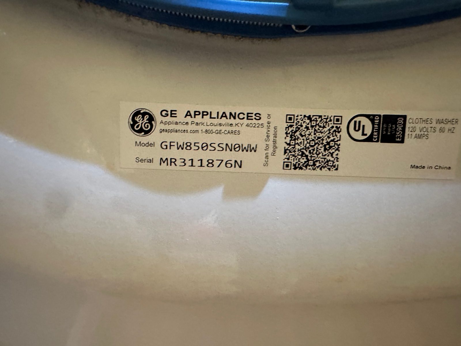 GE Appliances rating label inside the washer door showing model GFW850SSN0WW, clothes washer, 120 volts