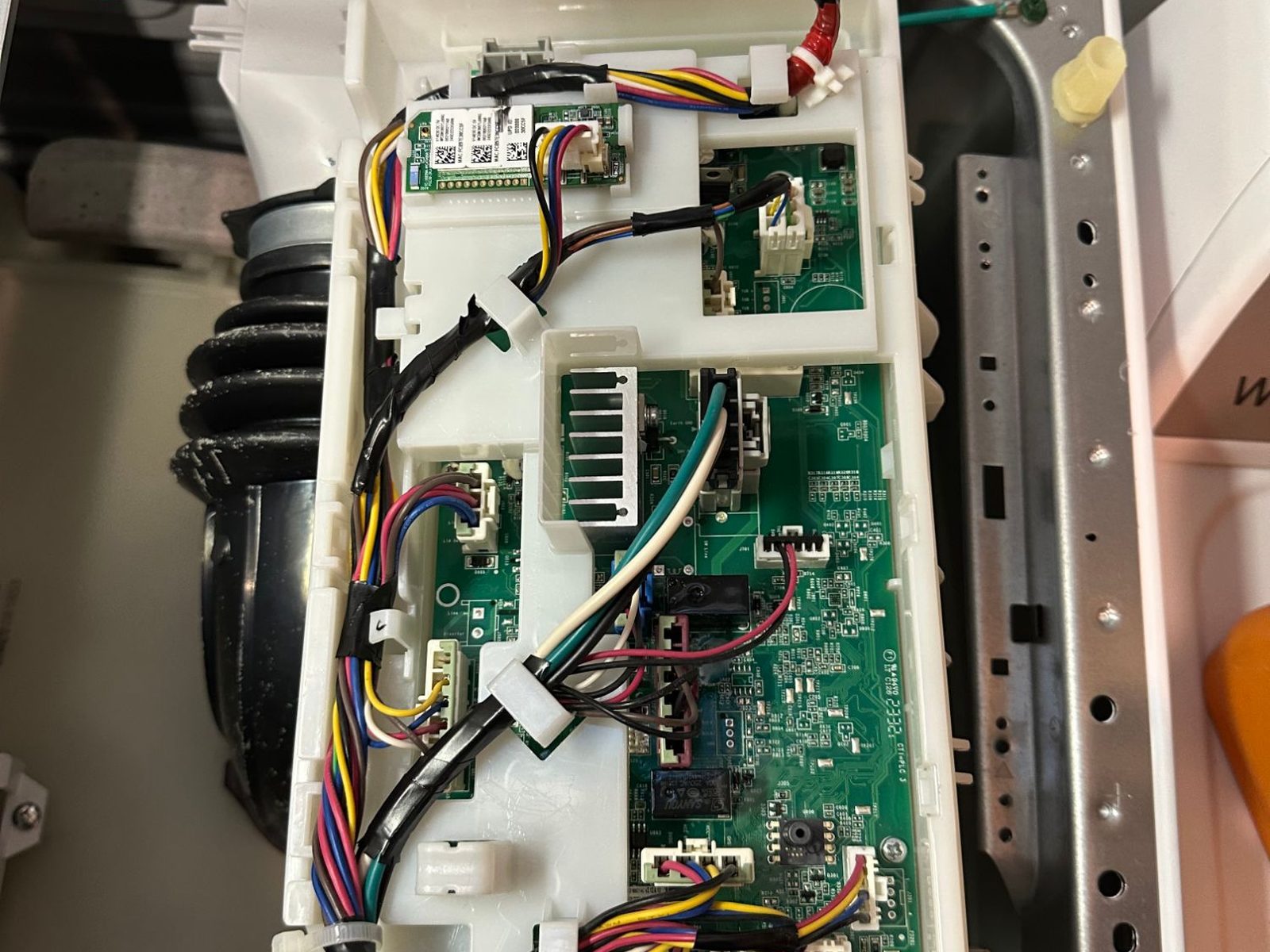 New main control board installed and rewired in a GE front-load washer in Kenmore