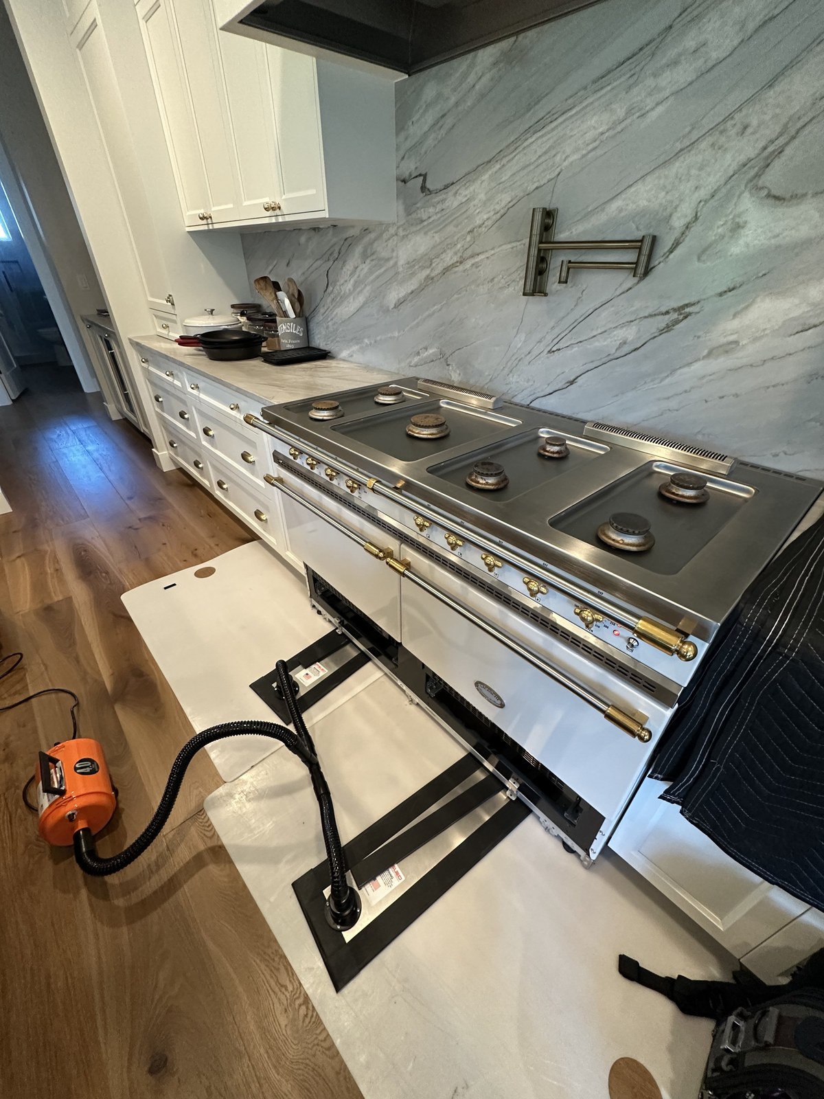 Lacanche range with oven doors removed for an electrical and wiring repair