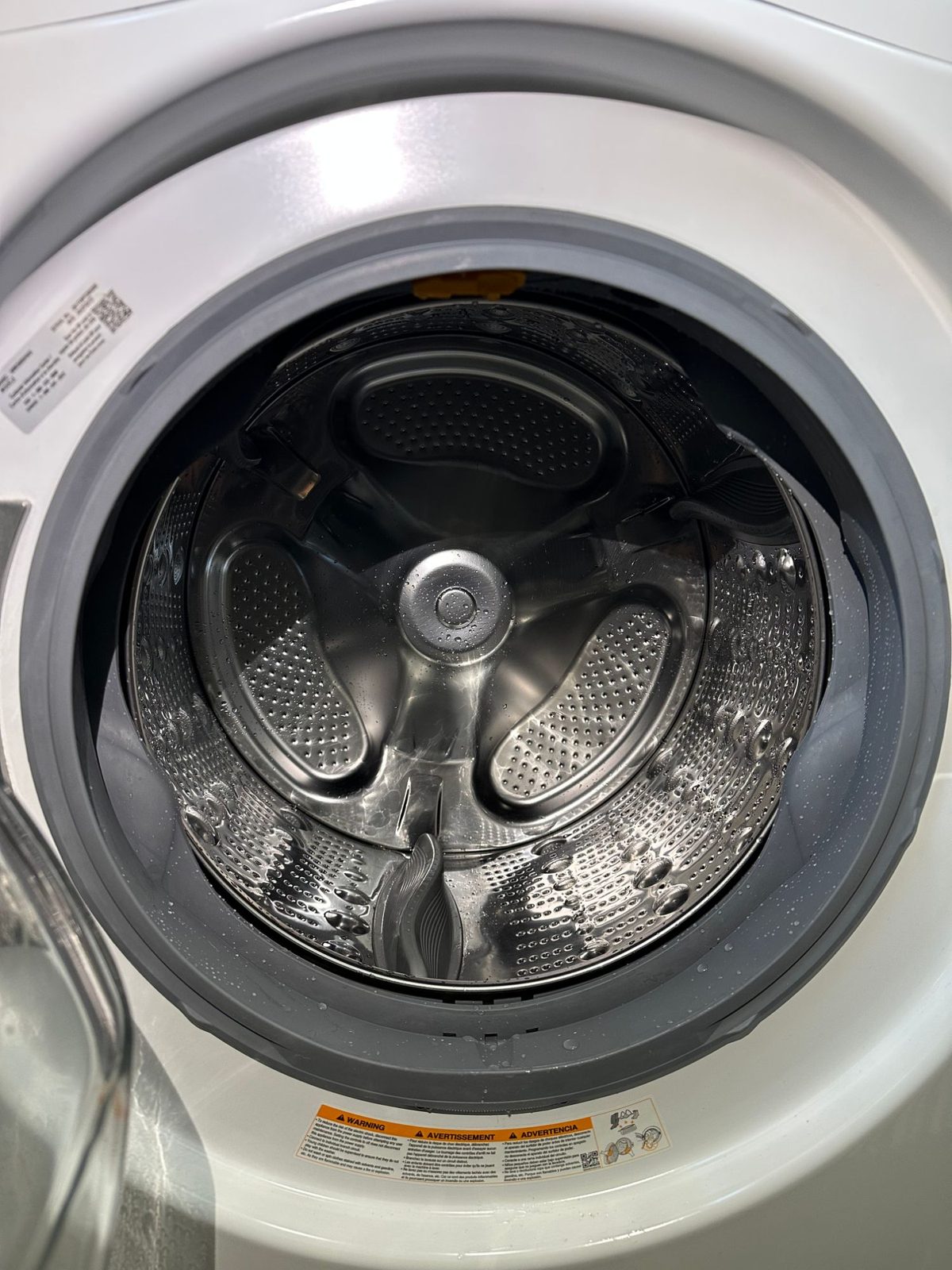 Close-up of the LG washer drum and the new door boot gasket with water droplets after a test run