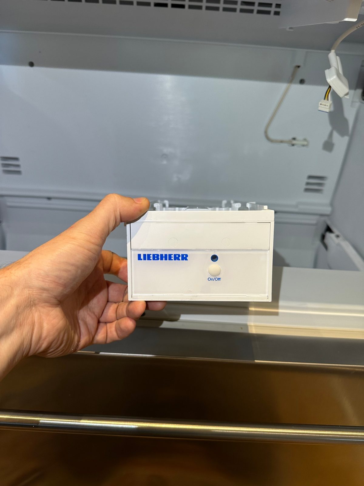 Liebherr IceMaker module held out of the upper freezer drawer compartment of a CS 2060