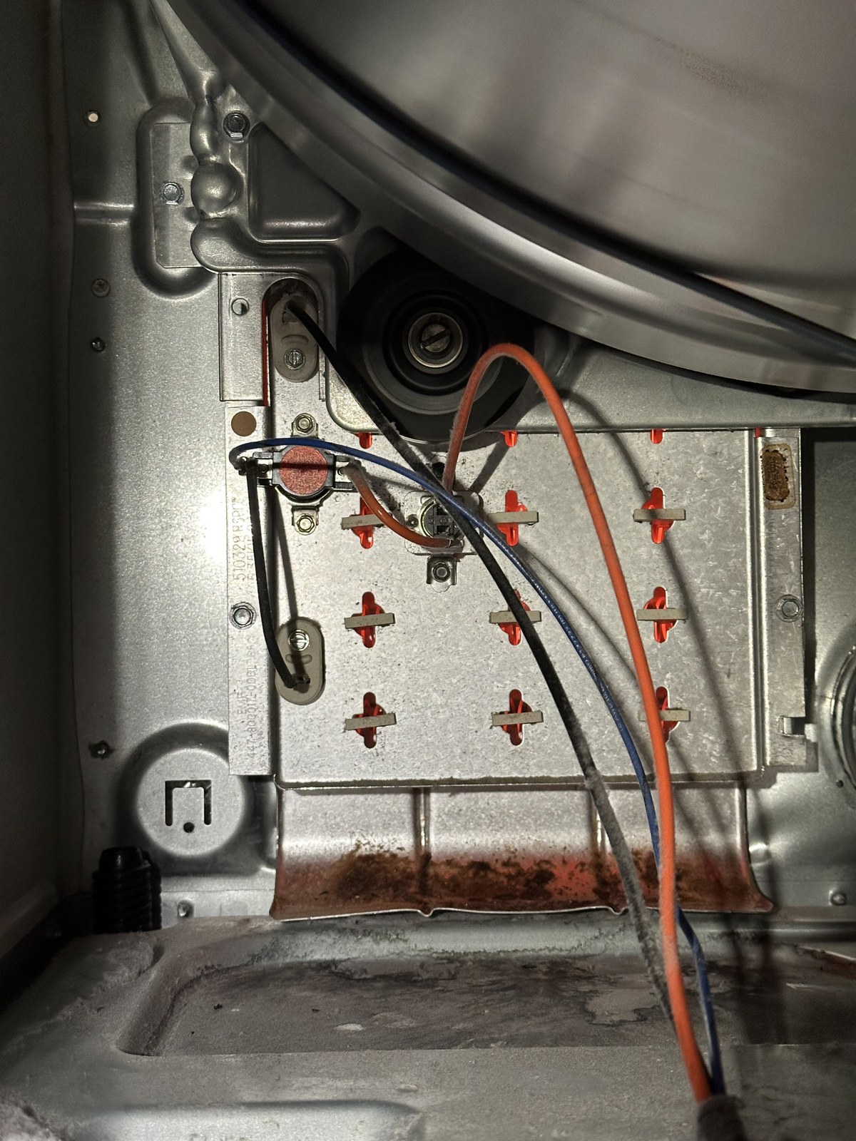 Speed Queen dryer with the rear panel open, exposing the heating element assembly and wiring for replacement