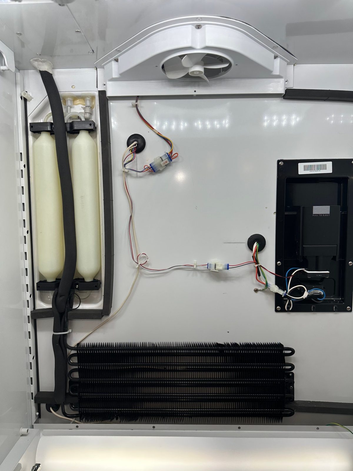 New Sub-Zero evaporator in place with its refrigerant line wrapped in black foam insulation and tied down