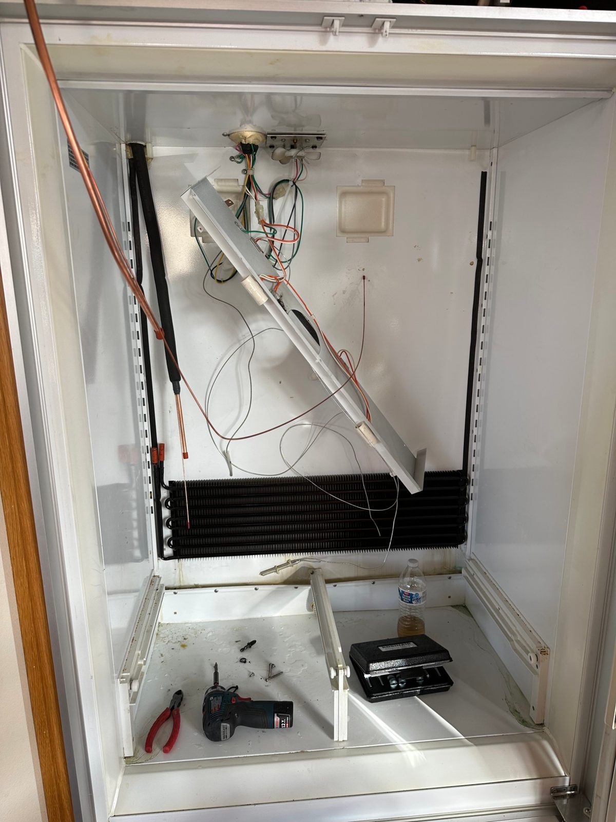 New OEM evaporator coil installed in the Sub-Zero 550 refrigerator section, with the new copper line ready to connect