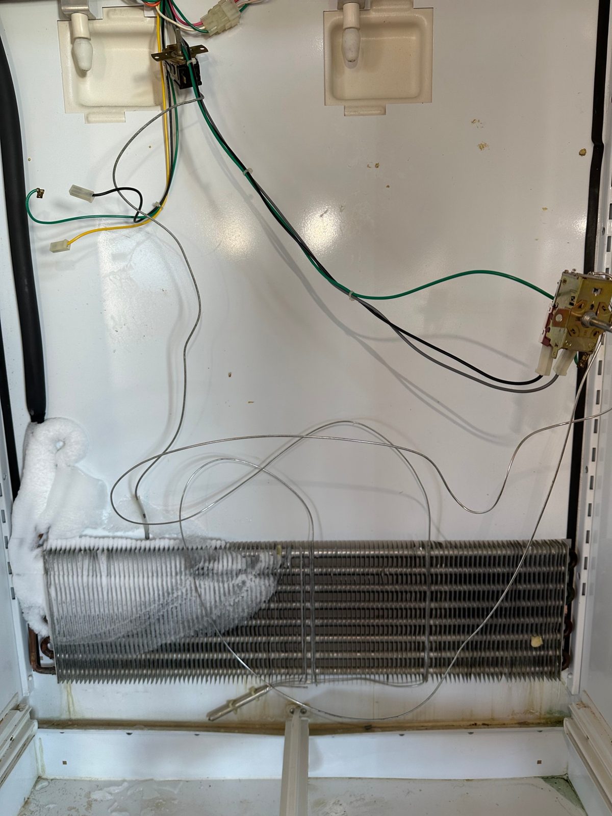 Original Sub-Zero 550 refrigerator evaporator with frost covering only part of the coil, back panel removed