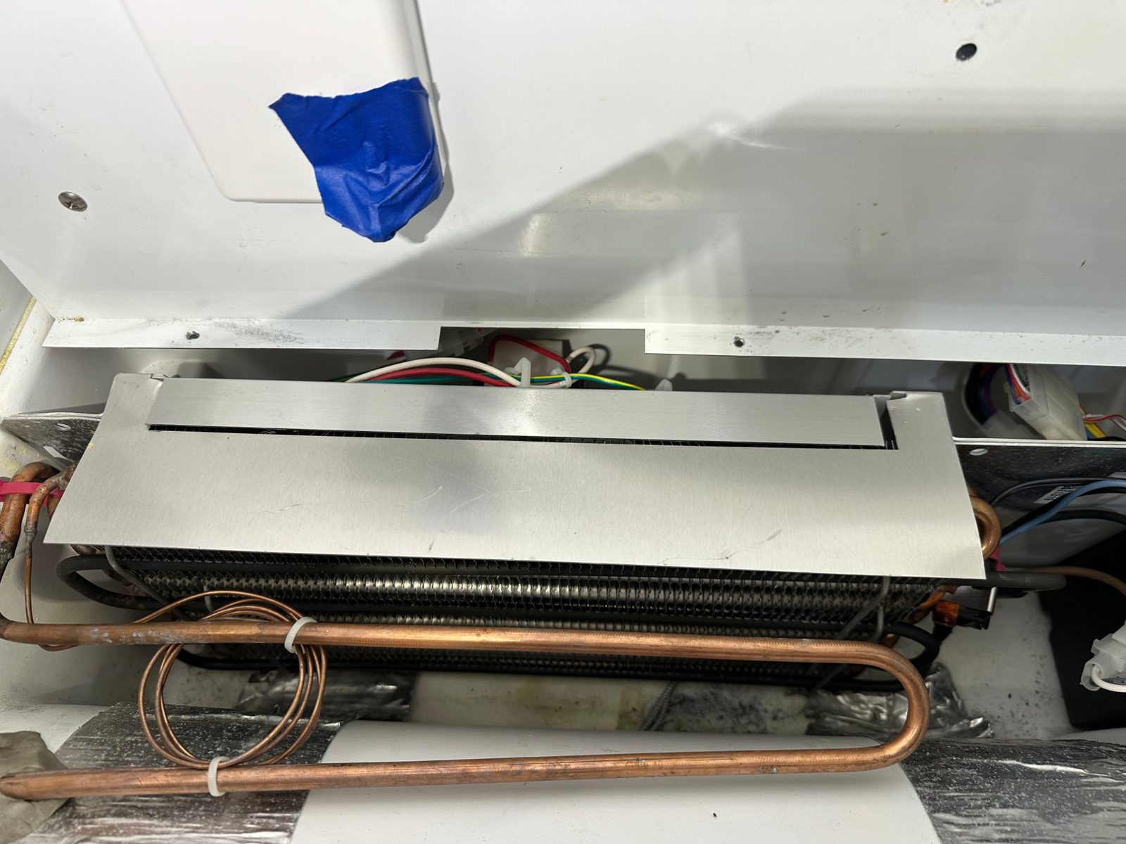 New evaporator coil and suction line in place at the back of the Sub-Zero freezer compartment