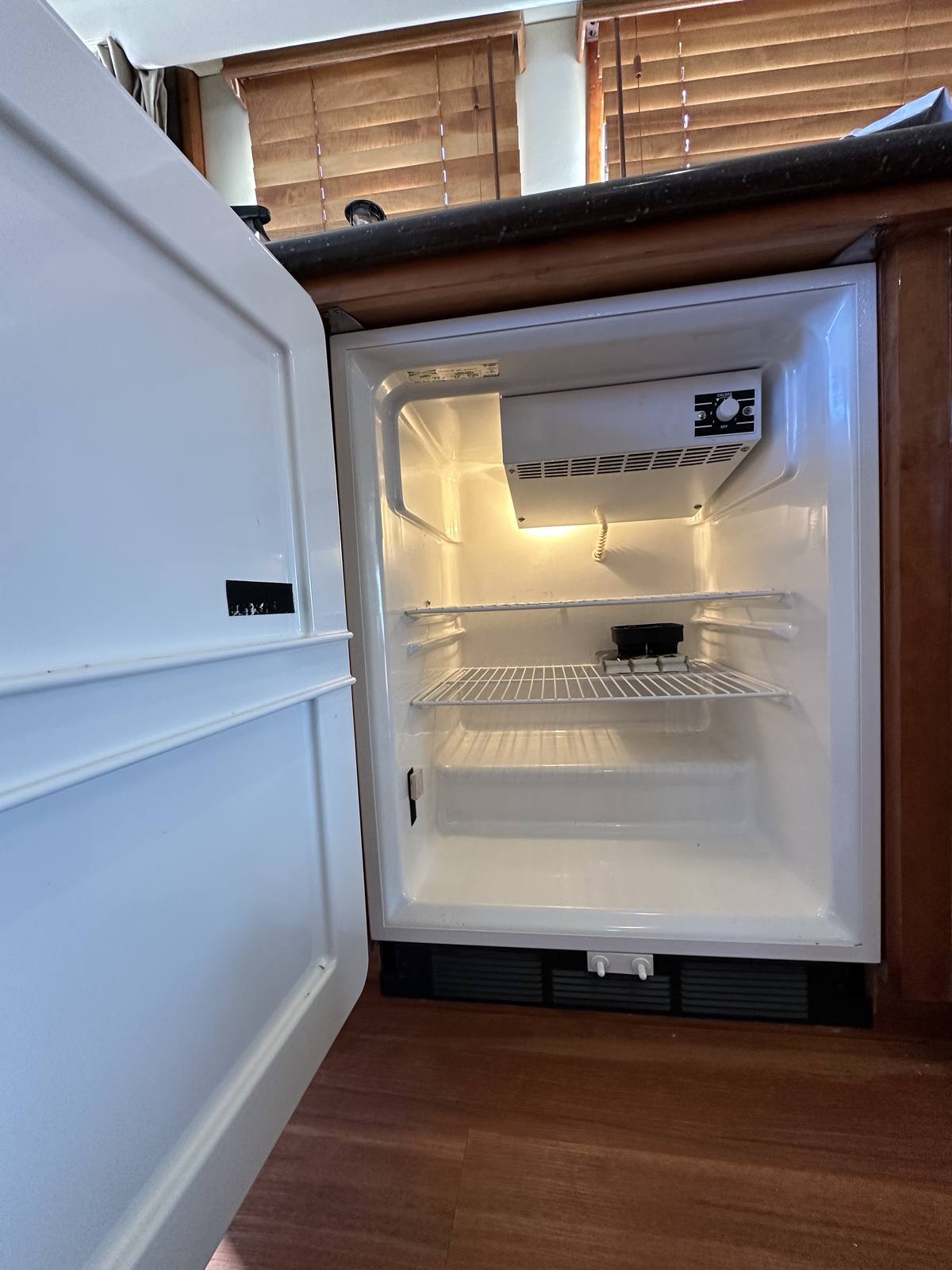 Sub-Zero freezer running after repair, door open showing a cold, frost-free interior