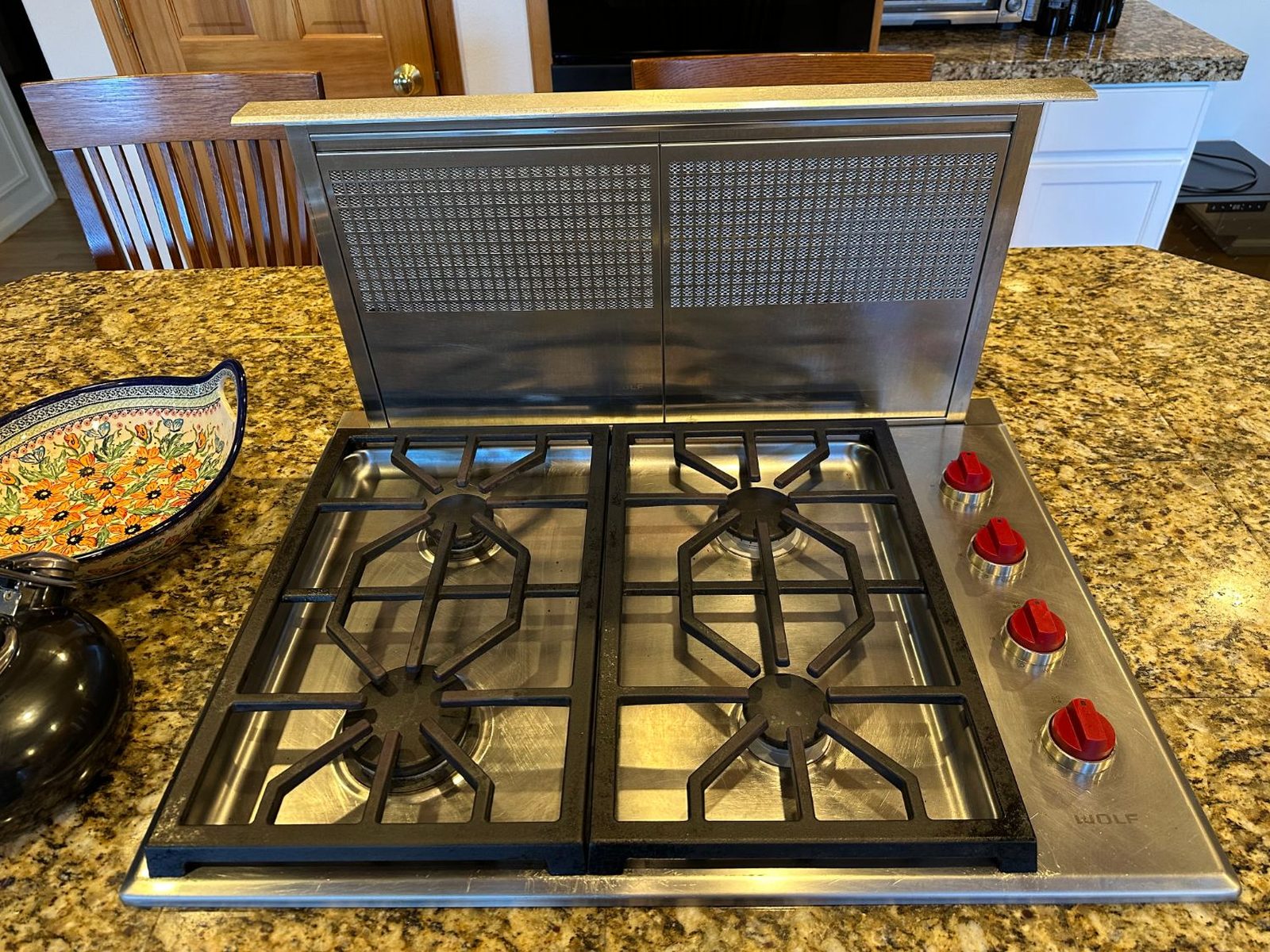 Wolf CG304P/S four-burner gas cooktop with a pop-up downdraft vent in a Redmond kitchen island
