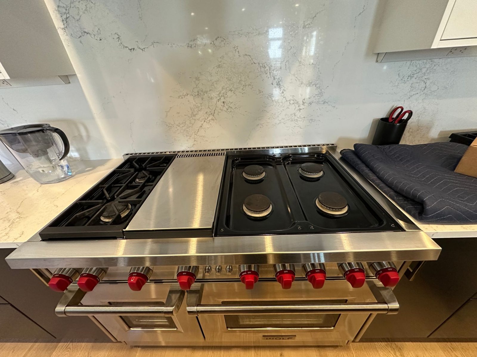 Wolf GR486G 48-inch gas range in a Kirkland kitchen with the grates removed from the four right-side burners