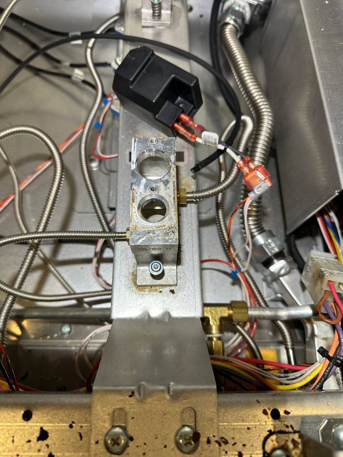 New Wolf spark module mounted and wired beside a burner base inside the Wolf GR486G range
