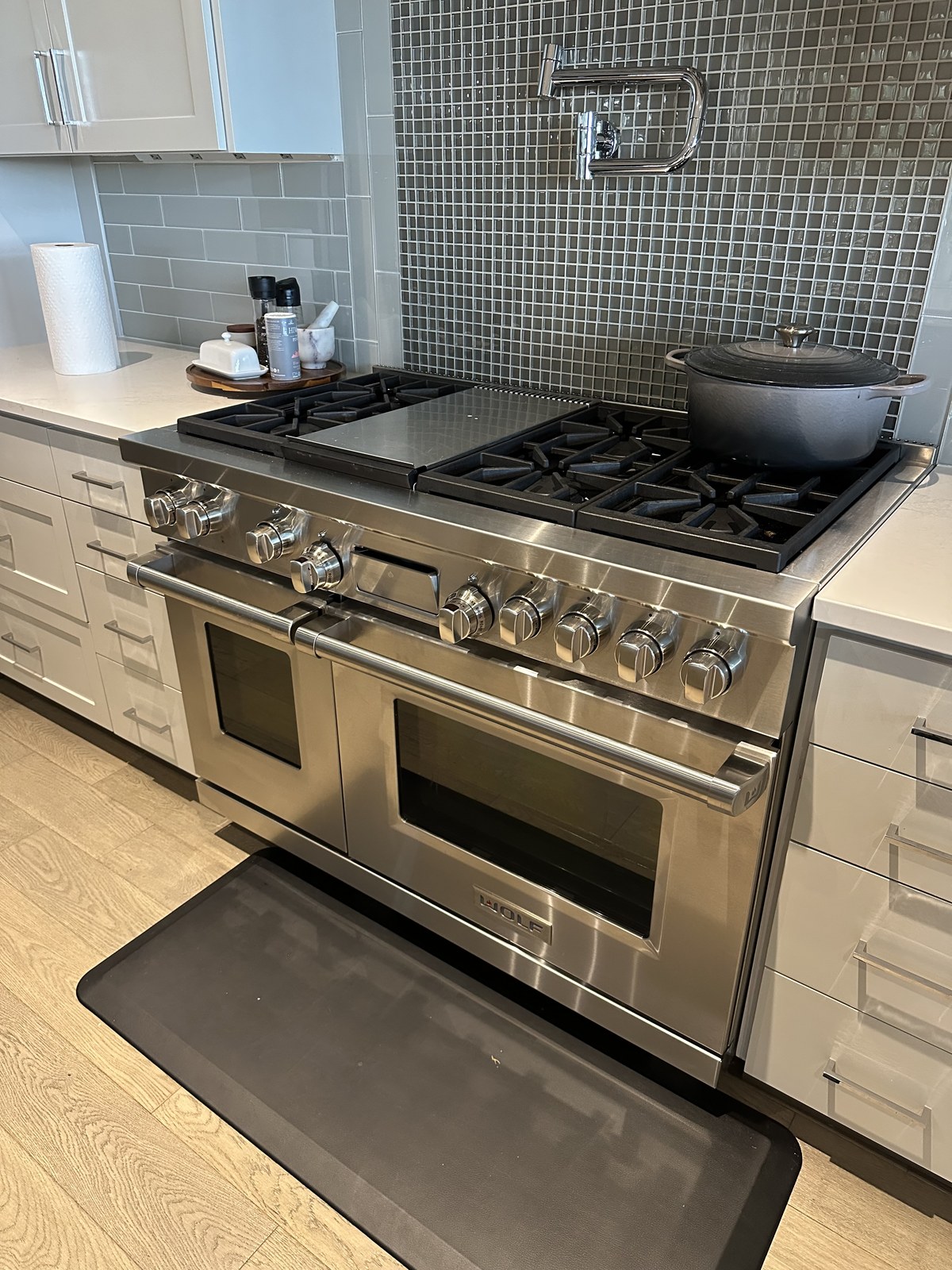Wolf dual-fuel range with griddle and gas cooktop in a residential kitchen