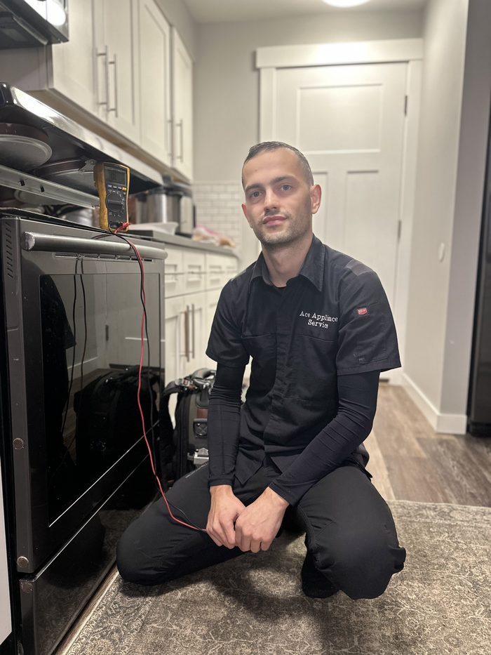 Max, lead technician of Ace Appliance Service, diagnosing an oven with a multimeter